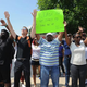 Protesters stand with their arms in the air during a protest of the shooting death of 18-year-old Michael Brown by a Ferguson, Mo., police officer, outside Ferguson Police Department headquarters Aug. 11, 2014. One protester holds a sign that reads, “Please do not shoot. My hands are up.”
Michael B. Thomas/Getty Images